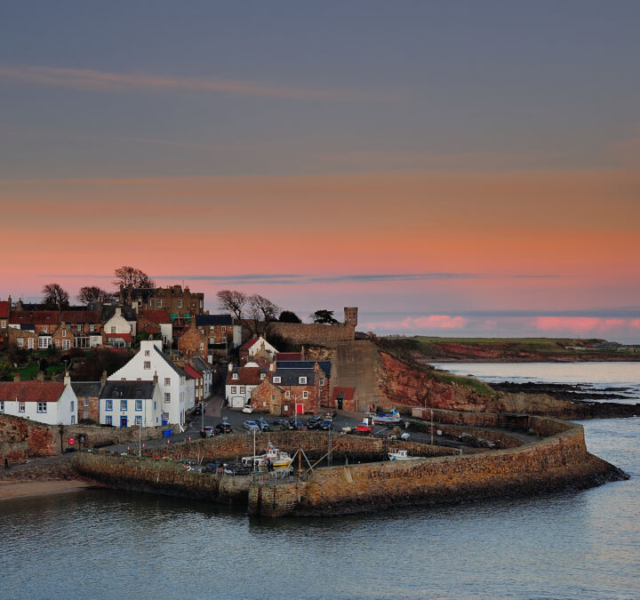 The quaint and picturesque fishing village and harbour of Crail in the East Neuk of Fife, as the last light of day fades across the Firth of Forth.