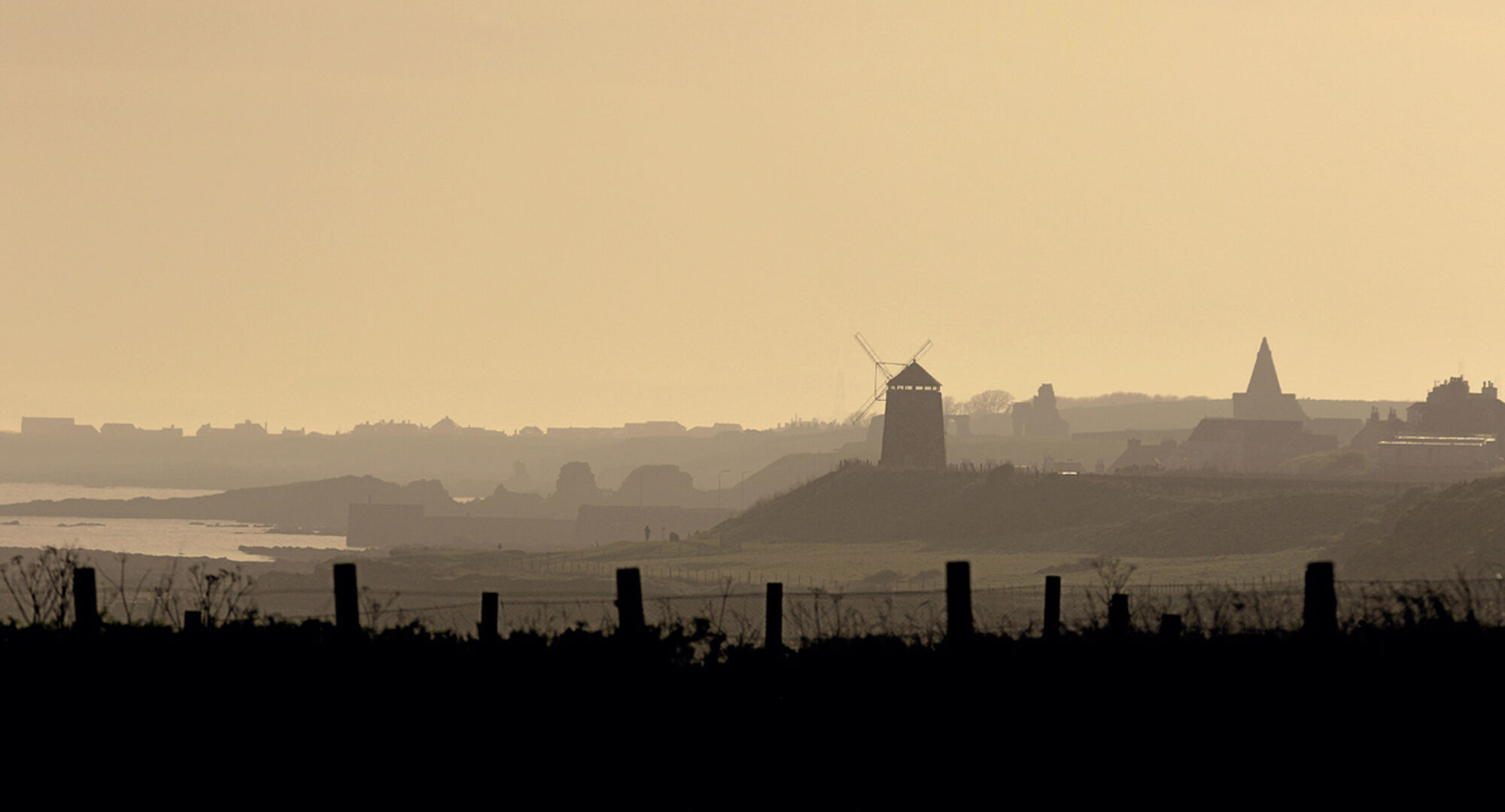 Coastal town in the East Neuk of Scotland with windmill in the middle ground