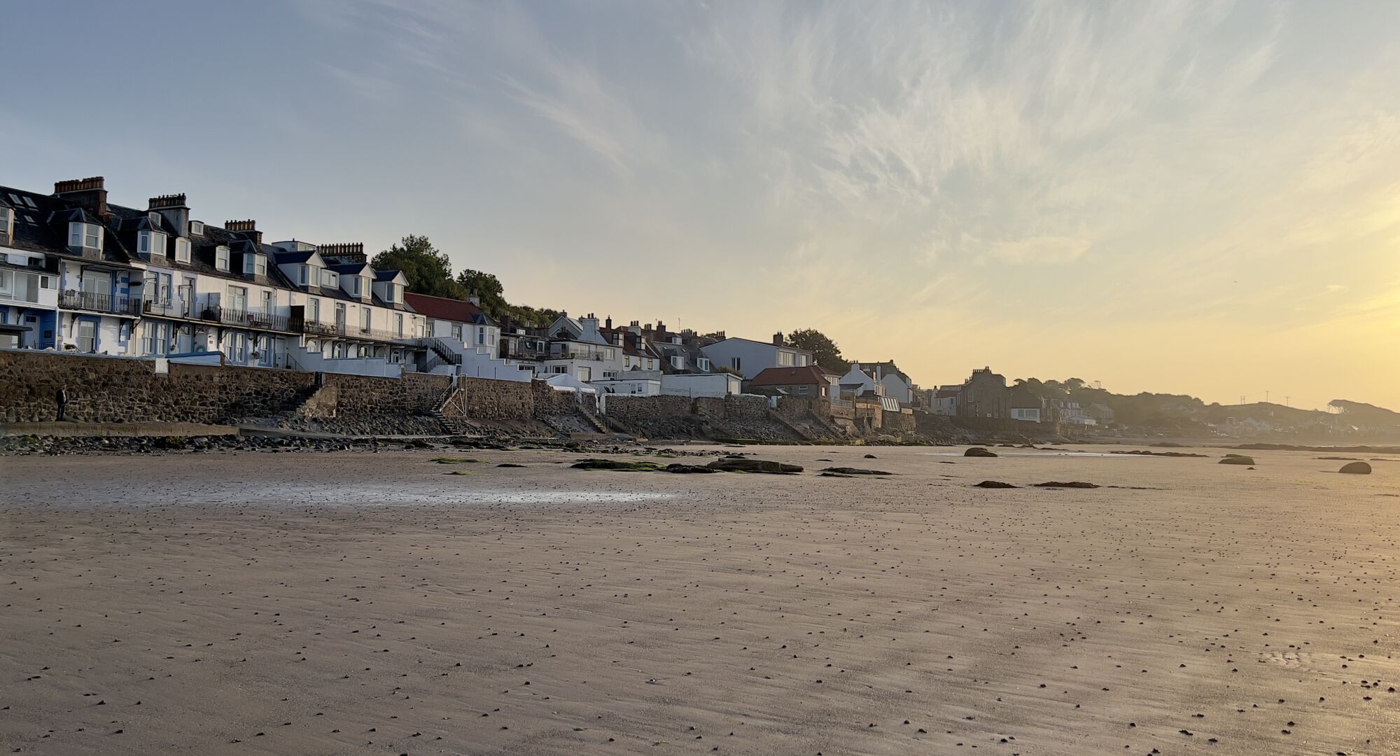 Rows of houses overlooking the beach at sunset