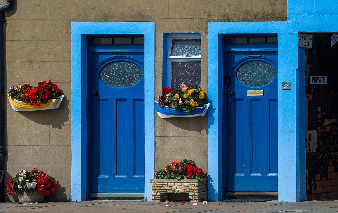 Houses with flowers and blue front doors