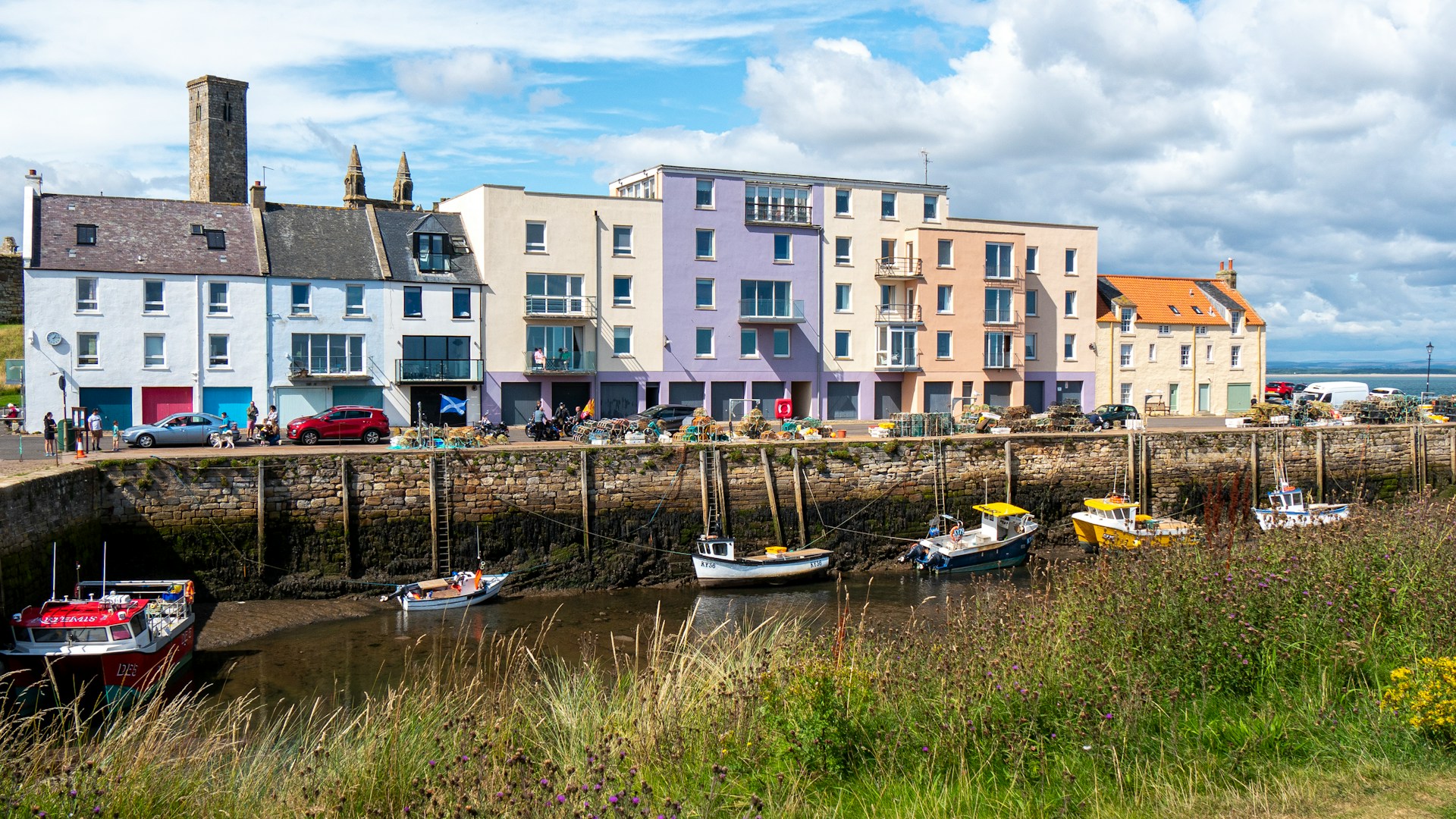 Multicoloured houses overlooking boats on the water in a harbour