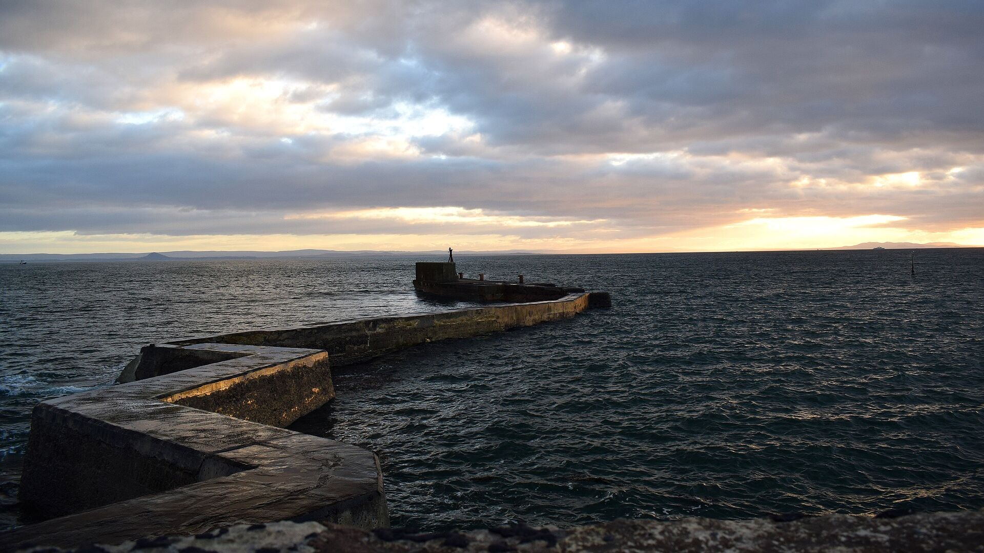 A winding stone jetty in the sea