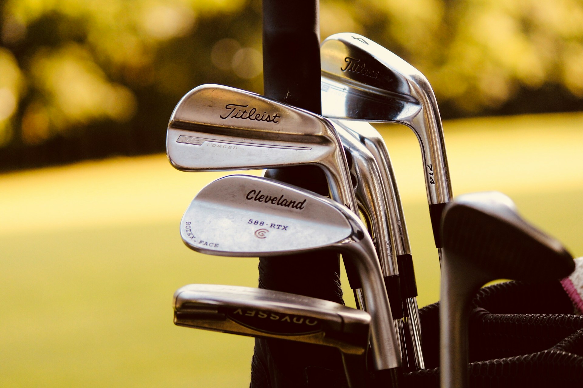 Grey steel golf clubs in focus