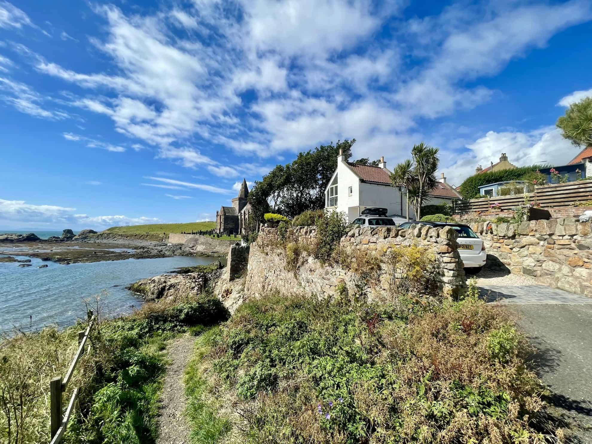 A white house on a hill overlooking the sea