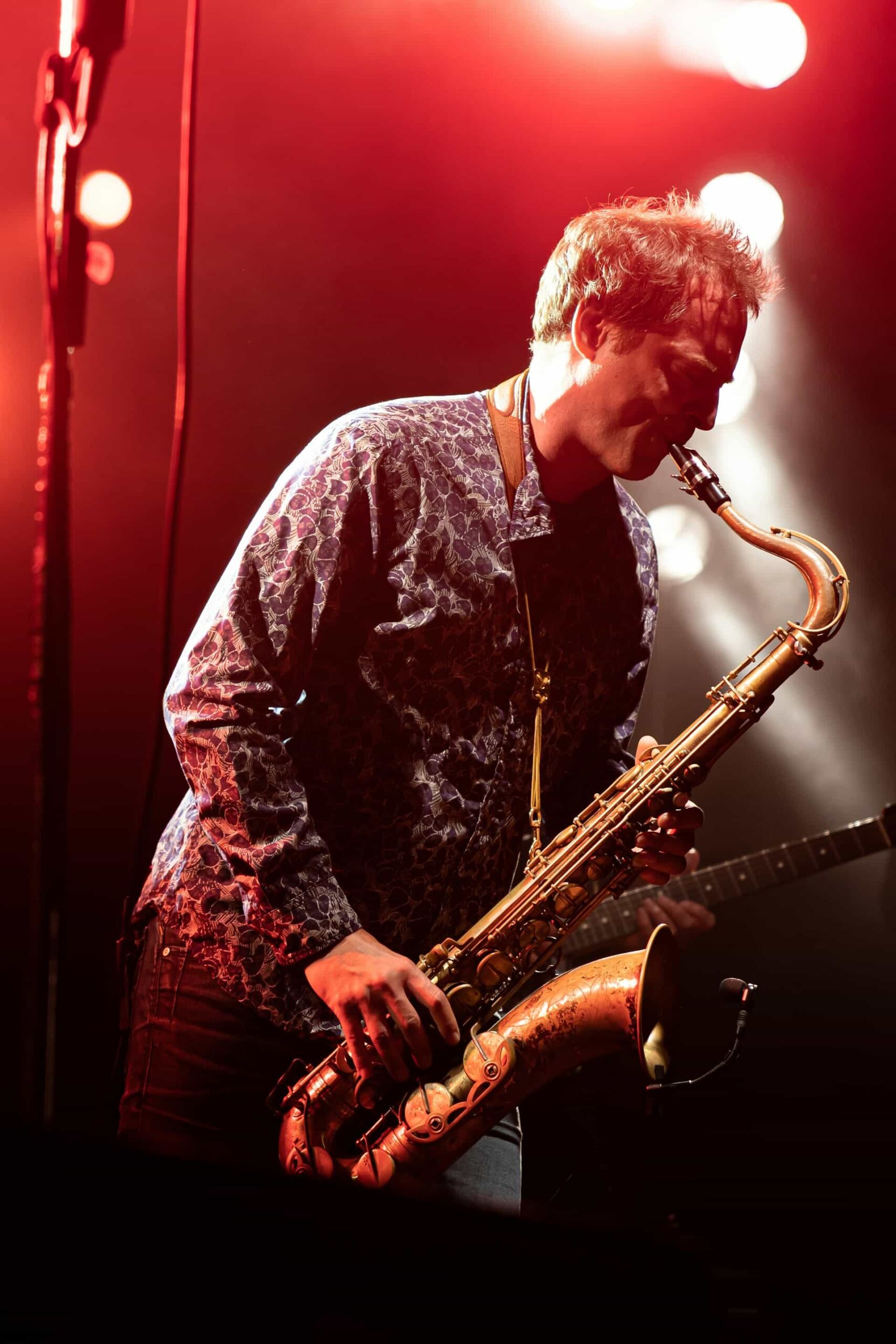 A man playing the saxophone on a stage