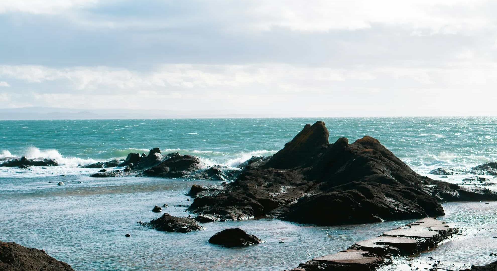 Rock formations in the sea on a cloudy day