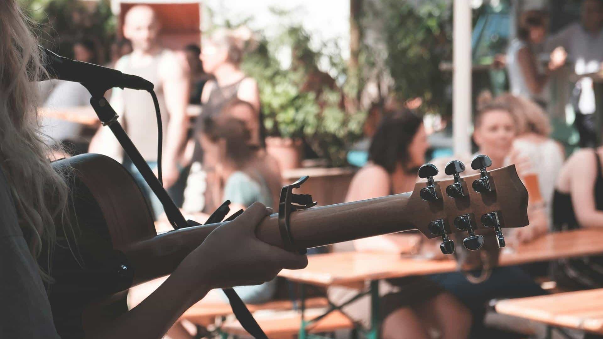 A person playing guitar in a bar