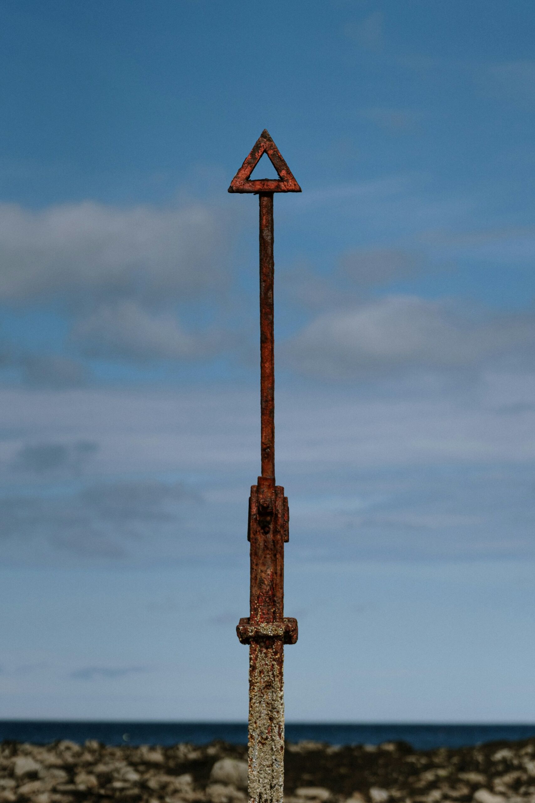 A brown metal sign overlooking the sea